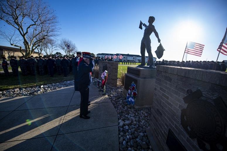 Coast Guard recruits and personnel from Training Center Cape May hold a Veterans Day ceremony in front of the Douglas Munro statue, along with members of multiple local Veterans groups, Nov. 11, 2018.