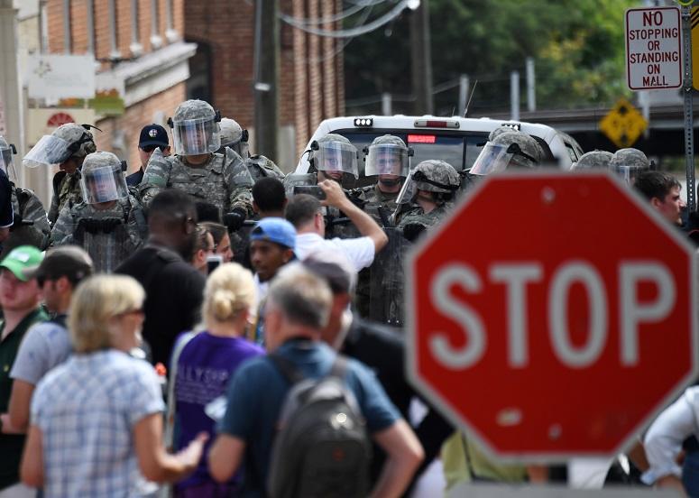 olice stand guard near the rally site in Charlottesville, Virginia, the United States, Aug. 12, 2017.