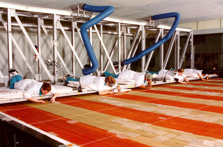 The flag was moved to a new specially-built conservation lab Museum visitors observed the conservation process through a 50-foot (15.2-m)-long glass wall. A moveable bridge (gantry) gave the conservation team a working surface above the flag.