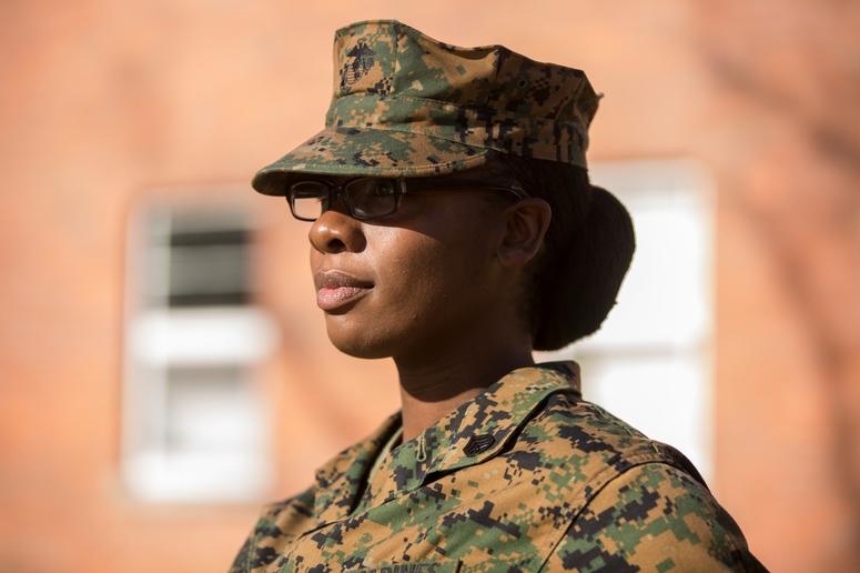 SSgt. Cherie Wright, Supply Chief with 2nd Air Naval Gunfire Liaison Company, Camp Lejeune, N.C., shows off her hairstyle, Dec. 16, which was recently approved by the Marine Corps. Her research and submission resulted in MARADMIN 622/15.