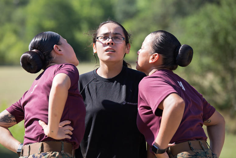 A poolee from Recruiting Station San Antonio gets yelled at by two drill instructors during an all-female pool function at Camp Bullis, Texas, July 22. Pool functions are held to prepare future Marines for the physical and mental stress of Marine Corps re