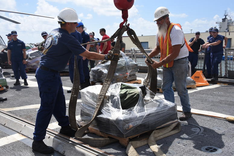 Coast Guard Cutter Bear (WMEC-901) crewmembers hook a pallet of interdicted drugs to a crane on the flight deck of the cutter April 18, 2019 at Port Everglades, Florida. The drugs were interdicted off the coasts of Mexico, Central, and South America and r Coast Guard Cutter Bear