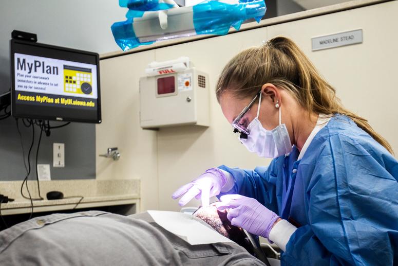 University of Iowa fourth-year dental student Madeline Stead works with Kenny Williams, a U.S. Army veteran from Rock Island, during an appointment on Monday, Nov. 12, 2018.