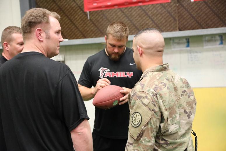 Atlanta Falcons Offensive Lineman, Ben Garland, signs footballs for Combined Joint Task Force – Operation Inherent Resolve members in the gym on Union III in Baghdad, Iraq, June 17, 2018.