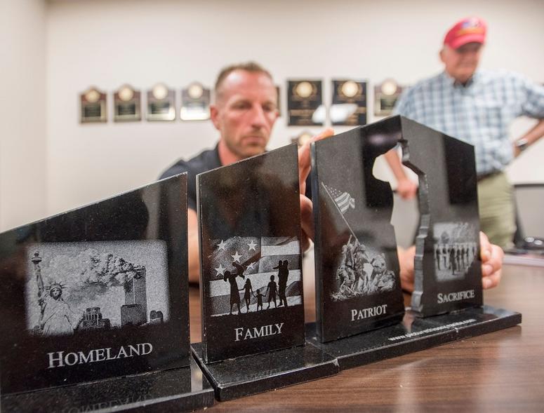 Jack Brown, right, looks on as Lt. Col. Dave Glassman, USMC (ret.), displays a model of the Gold Star Families memorial that he and a group are working to create in Pensacola.