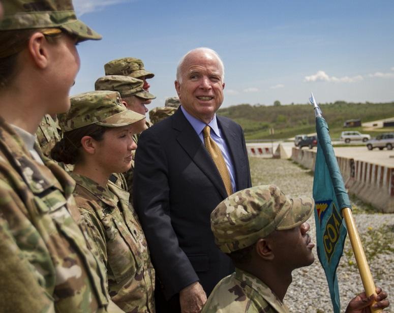 Senator John McCain poses with future graduates of the U.S. Army Basic Leader Course held on Camp Bondsteel, Kosovo, April 13, 2018.