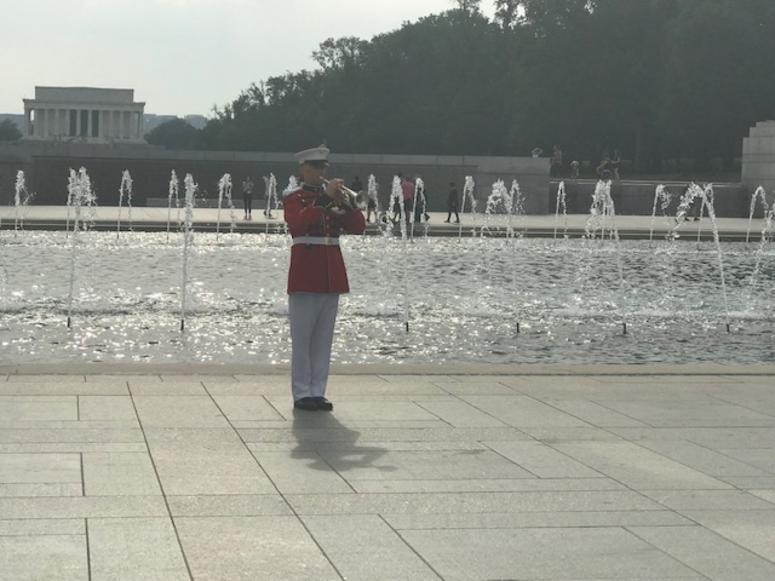 Taps is played at the World War II Memorial, where the names of all the fallen D-Day soldiers were read on Wednesday, June 5, 2019.