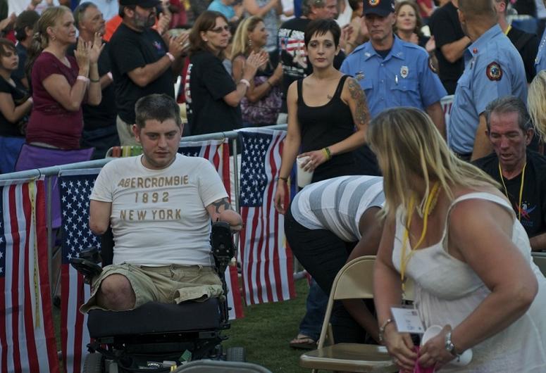 John Peck, enters the concert with the other veterans to a standing ovation. The Lt. Dan Band with Gary Sinise played at Waterfront Park for 74 wounded veterans and caregivers on Sept 15, 2012.