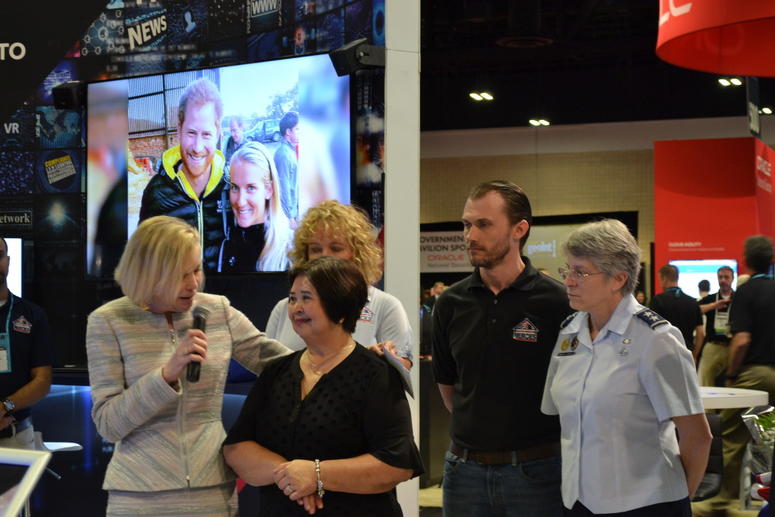 Engility CEO Lynn Dugle (L) presents Miriam Gonzalez, mother of retired U.S. Air Force Captain Gabriel Gonzalez, learns from Engility CEO Lynn Dugle that her son is getting a mortgage-free home from Building Homes for Heroes.