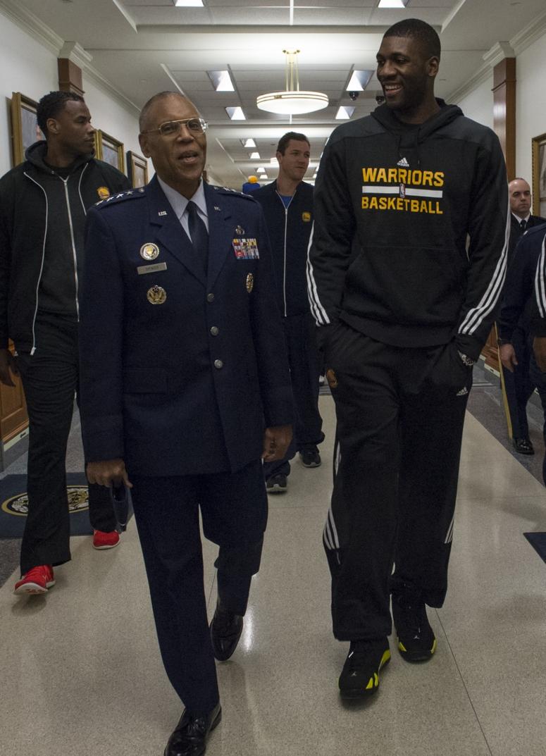 Vice Chief of Staff of the U.S. Air Force Gen. Larry O. Spencer talks with Festus Ezeli, a member of the Golden State Warriors basketball team, during the team's visit to the Pentagon.