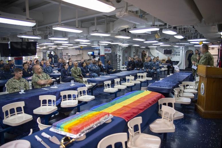 Sailors listen to the closing remarks of Capt. Larry McCullen, commanding officer of the amphibious assault ship USS Bonhomme Richard (LHD 6), during a Lesbian, Gay, Bisexual and Transgender (LGBT) Pride Month celebration on the ship’s mess deck.