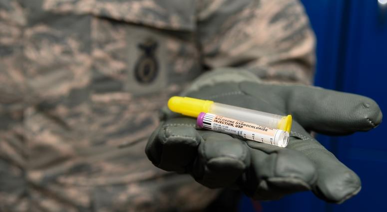 Staff Sergeant Matthew Pick, 66th Security Forces Squadron, holds a nasal applicator and naloxone medication vial, designed to temporarily reverse the effects of an opioid overdose Dec. 11 at Hanscom Air Force Base, Mass. NarcanNaloxene