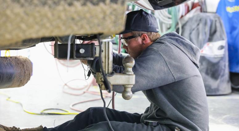 Former U.S. Army Spc. Kalob Johannsen, a former infantryman assigned to 2nd Battalion, 12th Infantry Regiment, 2nd Infantry Brigade Combat Team, 4th Infantry Division, works on a vehicle, March 23, 2019, during Caliber Collision Academy. TransitionAssistanceProgramTAP