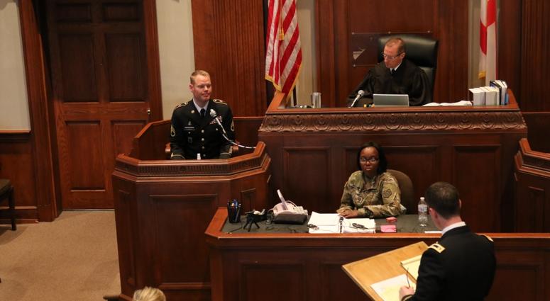 Trial Defense Council, questions the accused during the 4th annual 167th Theater Sustainment Command mock court martial.