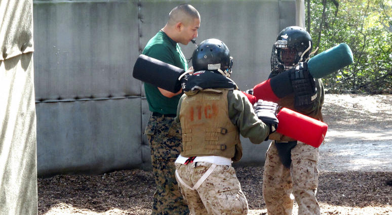 Female recruits battle with pugil sticks during training at the Marine Corps Training Depot