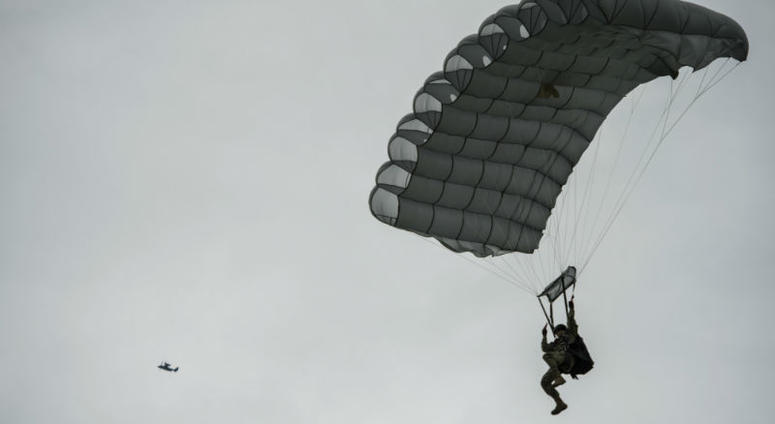 A military-free-fall paratrooper lands as a United States Air Force CV-22 Osprey. Over 1,000 U.S. paratroopers participate in largest airborne operation since WWII to commemorate 75th anniversary of D-Day.