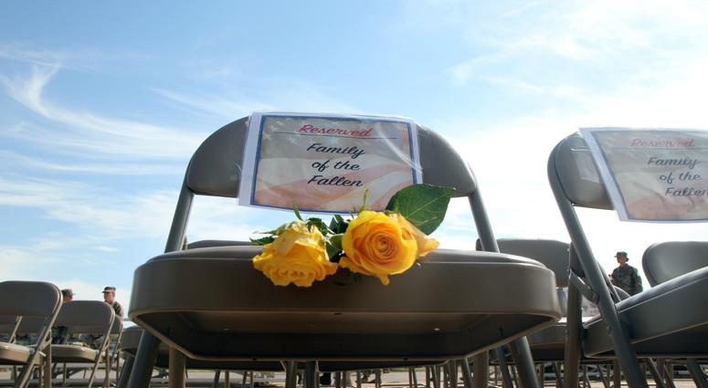 Yellow roses lay on a seat reserved for families of fallen South Dakota. Yellow roses are given as a symbol to honor family members of Soldiers who have made the ultimate sacrifice in service to their country.