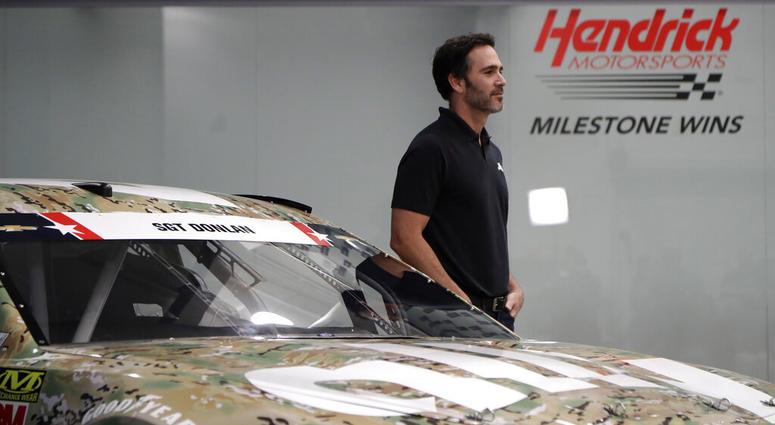 Jimmie Johnson stands by his race car for the Coca-Cola 600 NASCAR Cup series auto race Johnson to honor fallen soldier, military at Coca-Cola 600
