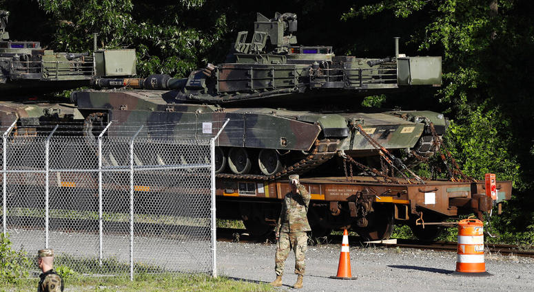 Military police walk near Abrams tanks on a flat car in a rail yard, Monday, July 1, 2019, in Washington, ahead of a Fourth of July celebration that President Donald Trump says will include military hardware. Military police walk near Abrams tanks on a flat car in a rail yard, Monday, July 1, 2019, in Washington, ahead of a Fourth of July celebration that President Donald Trump says will include military hardware.