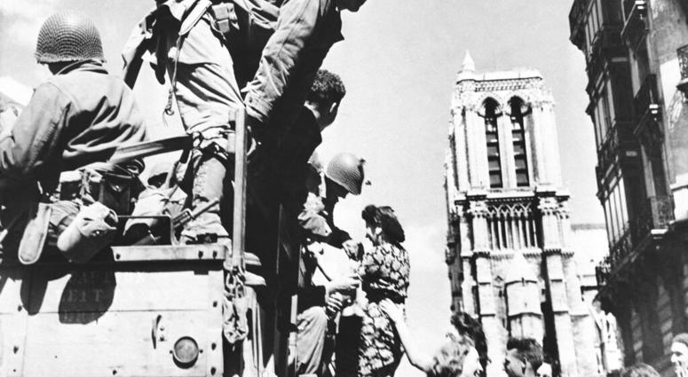 In this Aug. 28, 1944 file photo, French girls rush to greet American soldiers