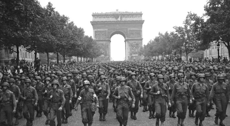 In this Aug. 29, 1944 file photo, U.S. soldiers of Pennsylvania's 28th Infantry Division march along the Champs Elysees