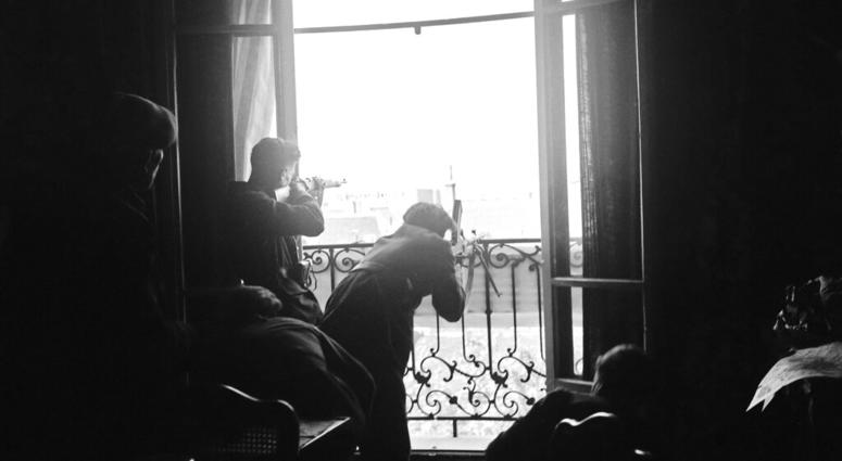 This Aug. 26, 1944 file photo shows members of the French Forces of the Interior (FFI) shoot at German snipers