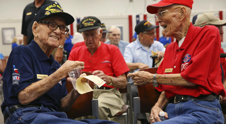 World War II veterans George Thomas, 97, left, and Clark Wilson, 93, enjoy conversation before a ceremony