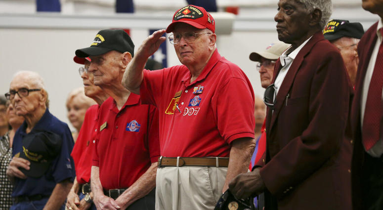 LeRoy Leonard, 93, salutes as the 323rd Army Band plays the U.S. military songs during a ceremony at Joint Base San Antonio-Fort Sam Houston