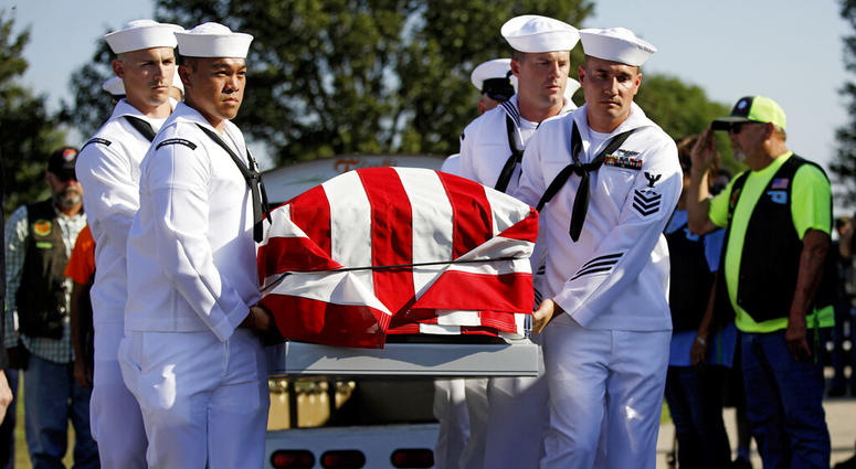 Sailors carry the casket of World War II veteran Herman White