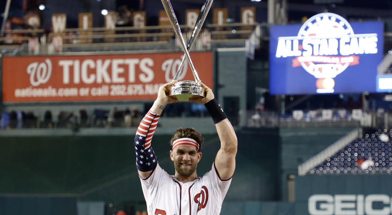 Washington Nationals right fielder Bryce Harper (34) celebrates winning the 2018 MLB home run derby at Nationals Ballpark.