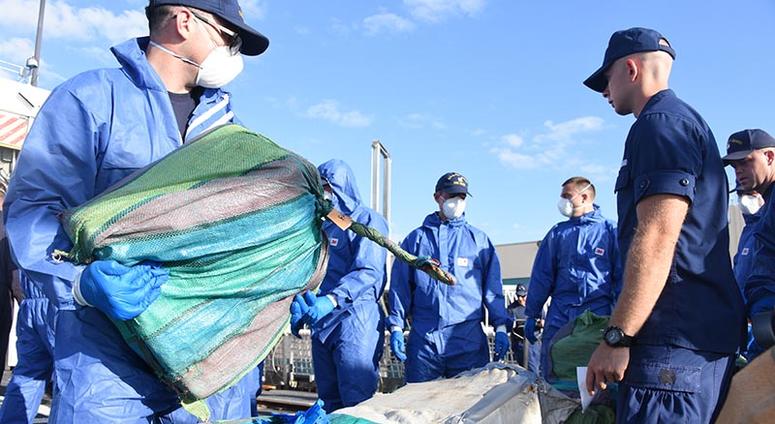 Coast Guard Cutter Bear (WMEC-901) crewmembers stage interdicted drugs on the flight deck of the cutter April 18, 2019 at Port Everglades, Florida. The drugs were interdicted off the coasts of Mexico, Central, and South America and represent five separate Coast Guard Cutter Bear