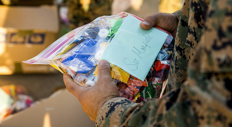 U.S. Marines with Special Purpose Marine Air-Ground Task Force-Crisis Response-Africa receive care packages on the flight line at Morón Air Base, Spain, Nov.23, 2017. SPMAGTF-CR-AF is deployed to conduct limited crisis-response and theater-security operat