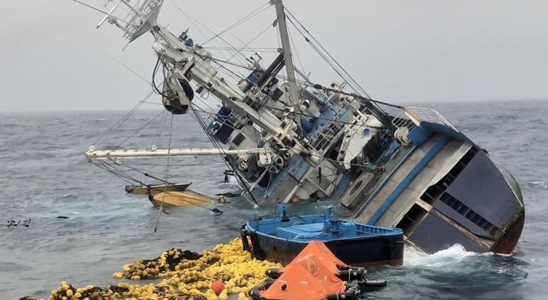 Fishing nets, life rafts, and debris from the 160-foot Ecuadorian fishing vessel Marujita float behind the capsizing vessel approximately 336 miles southeast of Clipperton Island, August 7, 2019. Twenty five crew members and 12 Coast Guardsmen who abandon Coast Guard rescues 37 people after fishing boat capsizes, sinks in the Eastern Pacific Ocean