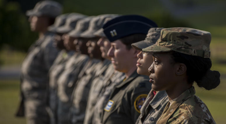 U.S. Air Force Airmen stand at attention during a retreat ceremony Mar. 30, 2018, on Kadena Air Base, Japan. An all-female formation was coordinated in honor of Women’s History Month, which brings attention to the accomplishments and achievements of women