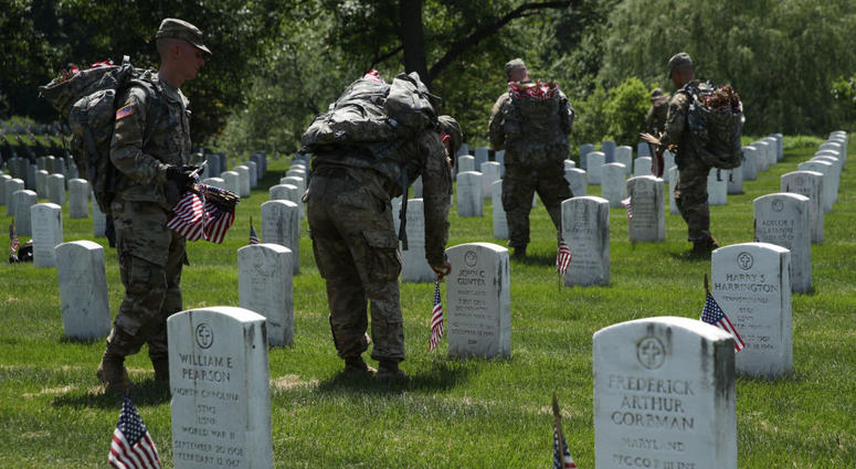 Soldiers with the U.S. Army 3rd Infantry Regiment (The Old Guard) participate in a "Flags In" event May 23, 2019 at Arlington National Cemetery in Arlington, Virginia. ArlingtonCemetery