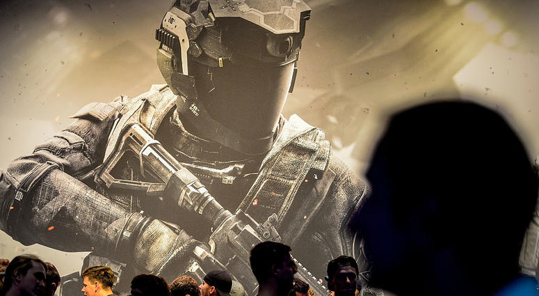 Visitors stand in front of the "Call of Duty" stand at the Gamescom 2016 gaming trade fair during the media day on August 17, 2016 in Cologne, Germany. CallofDuty