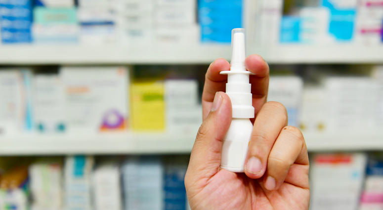 pharmacist holding nasal spray medicine - stock photo