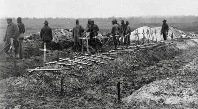 Filling in graves at Fère-en-Tardenois battlefield cemetery, France during World War I.