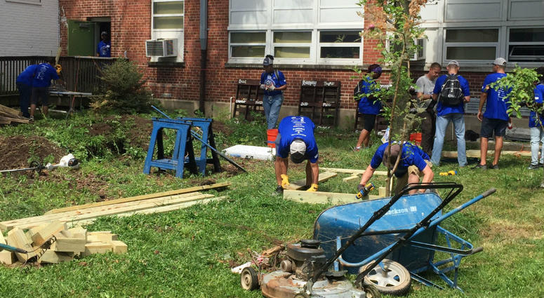 Veterans work to beautify a courtyard at Ben Franklin High School in Baltimore. 80 veterans from The Mission Continues at Ben Franklin High School in Baltimore.