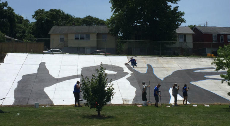 Veterans repaint the Love mural at Ben Franklin High School in Baltimore. 80 veterans from The Mission Continues at Ben Franklin High School in Baltimore.