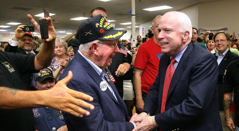 U.S. Sen. John McCain (R-Ariz.) greets veteran Earle Denton during a stop at the Romney campaign office in Casselberry, Florida, Tuesday, September 18, 2012.