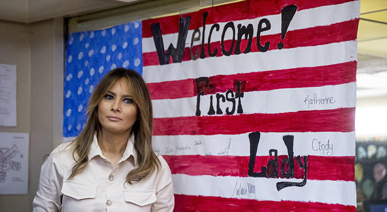 In this June 21, 2018 photo, First lady Melania Trump pauses after signing an artwork of an American flag while visiting the Upbring New Hope Children Center run by the Lutheran Social Services of the South in McAllen, Texas.
