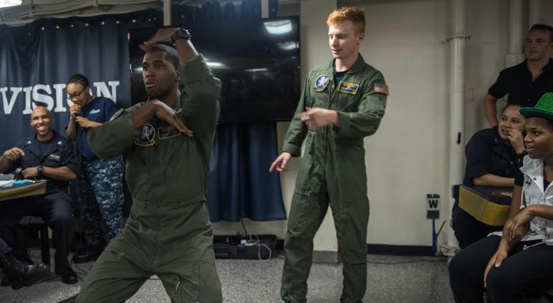 aval Air Crewmen (Helicopter) 3rd Class Bennett Grisley from Rochester, N.Y., and Naval Air Crewmen (Helicopter) 3rd Class Jordan Hunter from Phoenix perform during a lip-synch competition on USS John C. Stennis’ (CVN 74) mess decks. Providing a ready for SOUTH CHINA SEA