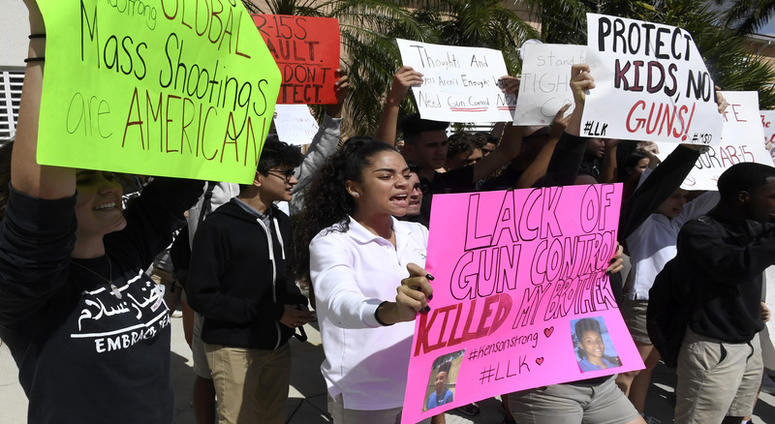 Pembroke Pines Charter High School students walk out of class to protest and read the names of the 17 people killed during the mass shooting at Parkland's Marjory Stoneman Douglas High School on Wednesday, Feb. 21, 2018.