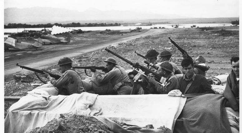 Marines and soldiers fire on raiding Japanese planes during the attack on Pearl Harbor.