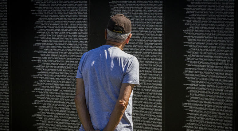 A Marine Corps veteran looks at the names of his friends lost in the Vietnam War on the American Veterans Traveling Tribute memorial wall, Sept. 17. The AVTT wall was in Boston from Sept. 16 through 20 in conjunction with the Congressional Medal of Honor South Boston's Vietnam War Memorial Is Rededicated