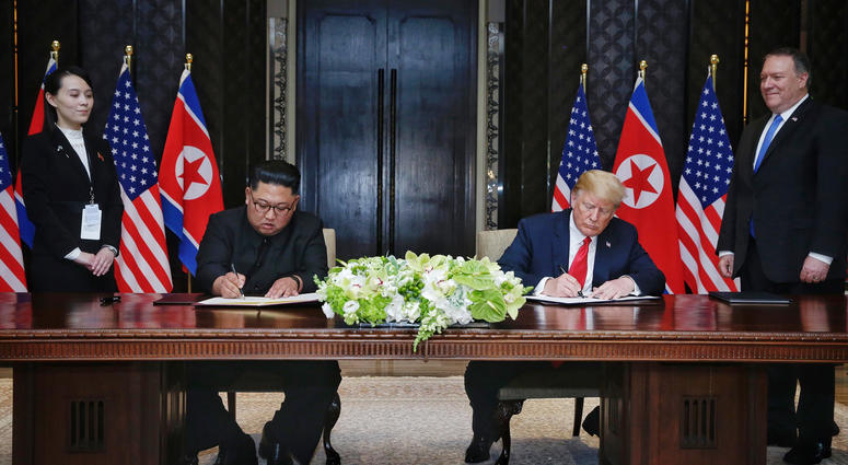 eader of the Democratic People's Republic of Korea (DPRK) Kim Jong Un (2nd L) and U.S. President Donald Trump (2nd R) sign a joint statement in Singapore on June 12, 2018.