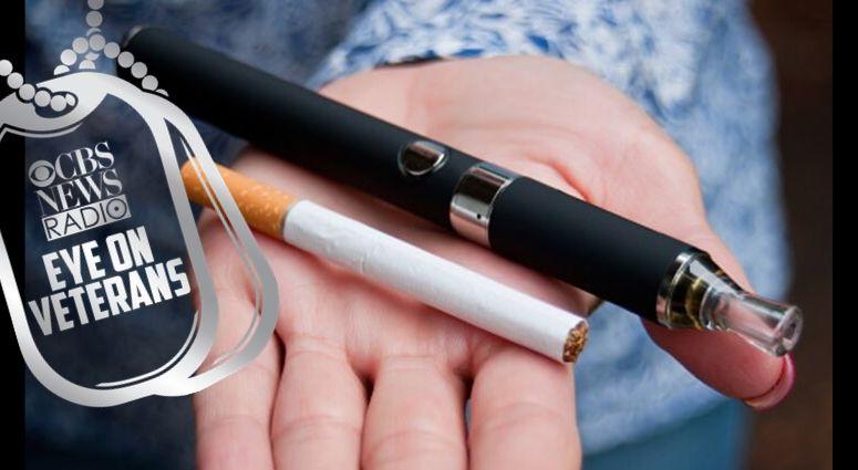 Hand holding e-cig and cigarettes. Doctors warns about vaping