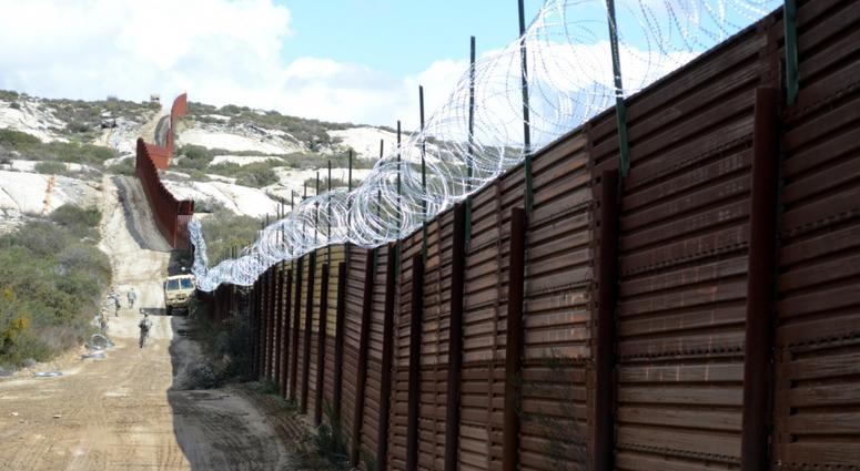 Soldiers with the 595th Sapper Company emplace strands of concertina wire along the border fence near Campo, Calif., March 8, 2019.
