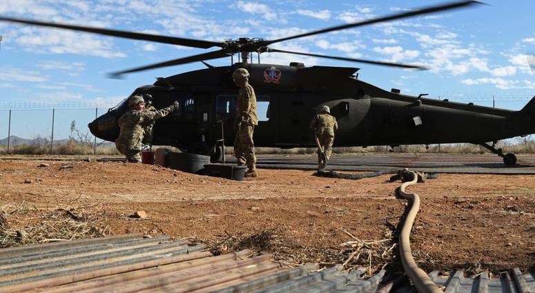 Soldiers from 227th Composite Supply Company, 101st Airborne Division, rush to refuel a UH60 Blackhawk in between aerial support missions in Sasabe, Arizona, Nov. 20, 2018.